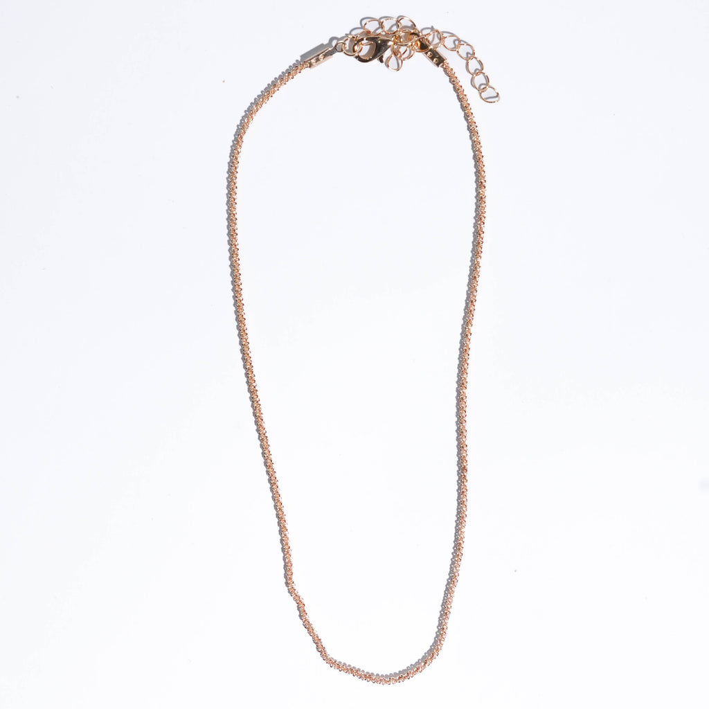 Gold necklace on a white background