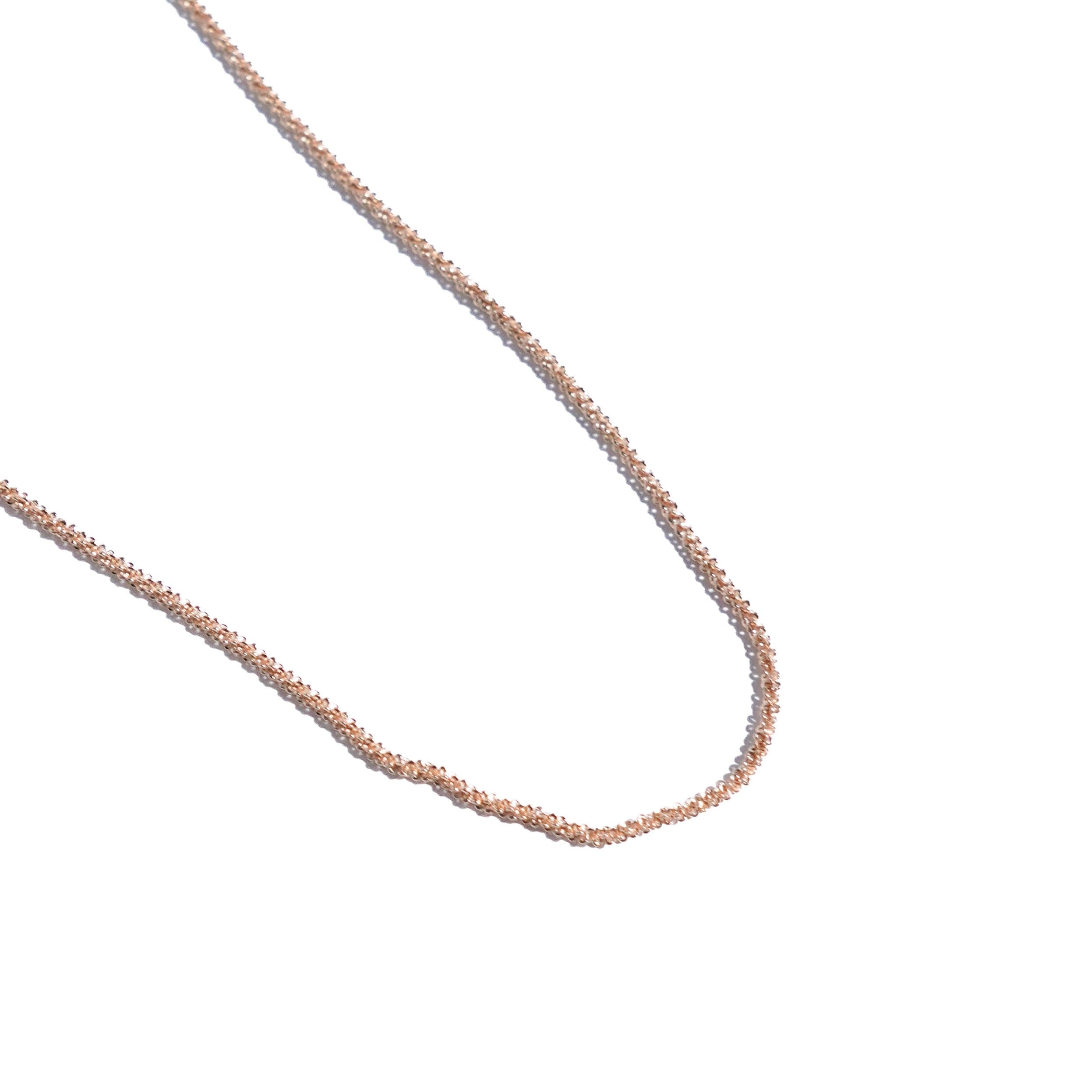 Rose gold chain on a white background