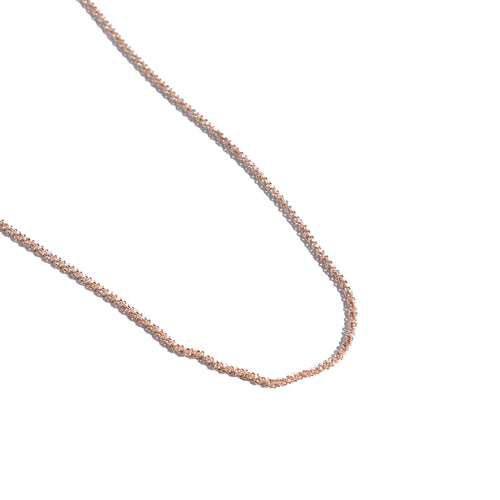 Rose gold chain on a white background