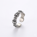 Silver floral-patterned ring on a white background