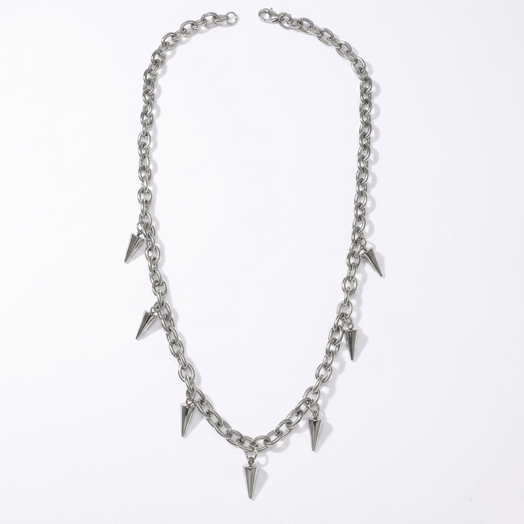 Silver chain necklace with spike-like pendants on a white background