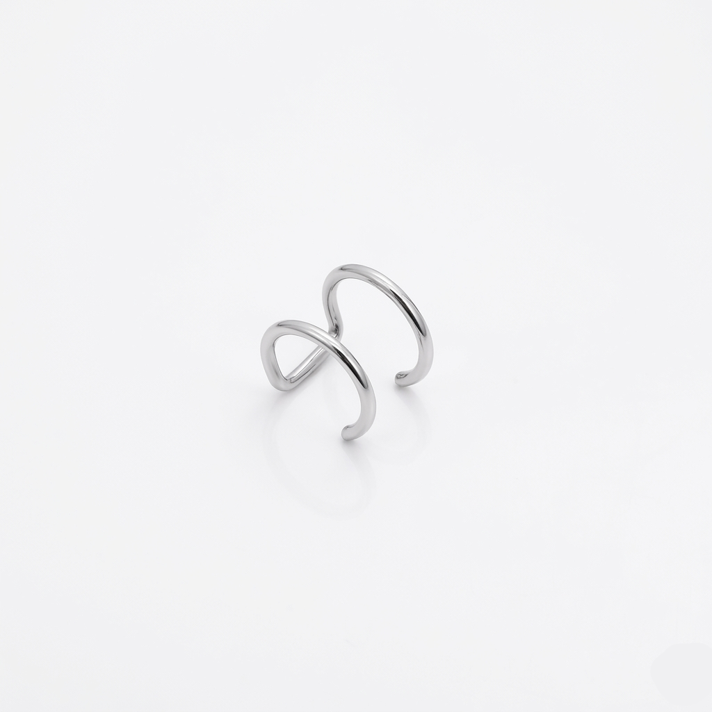 Silver infinity ring on a light gray background